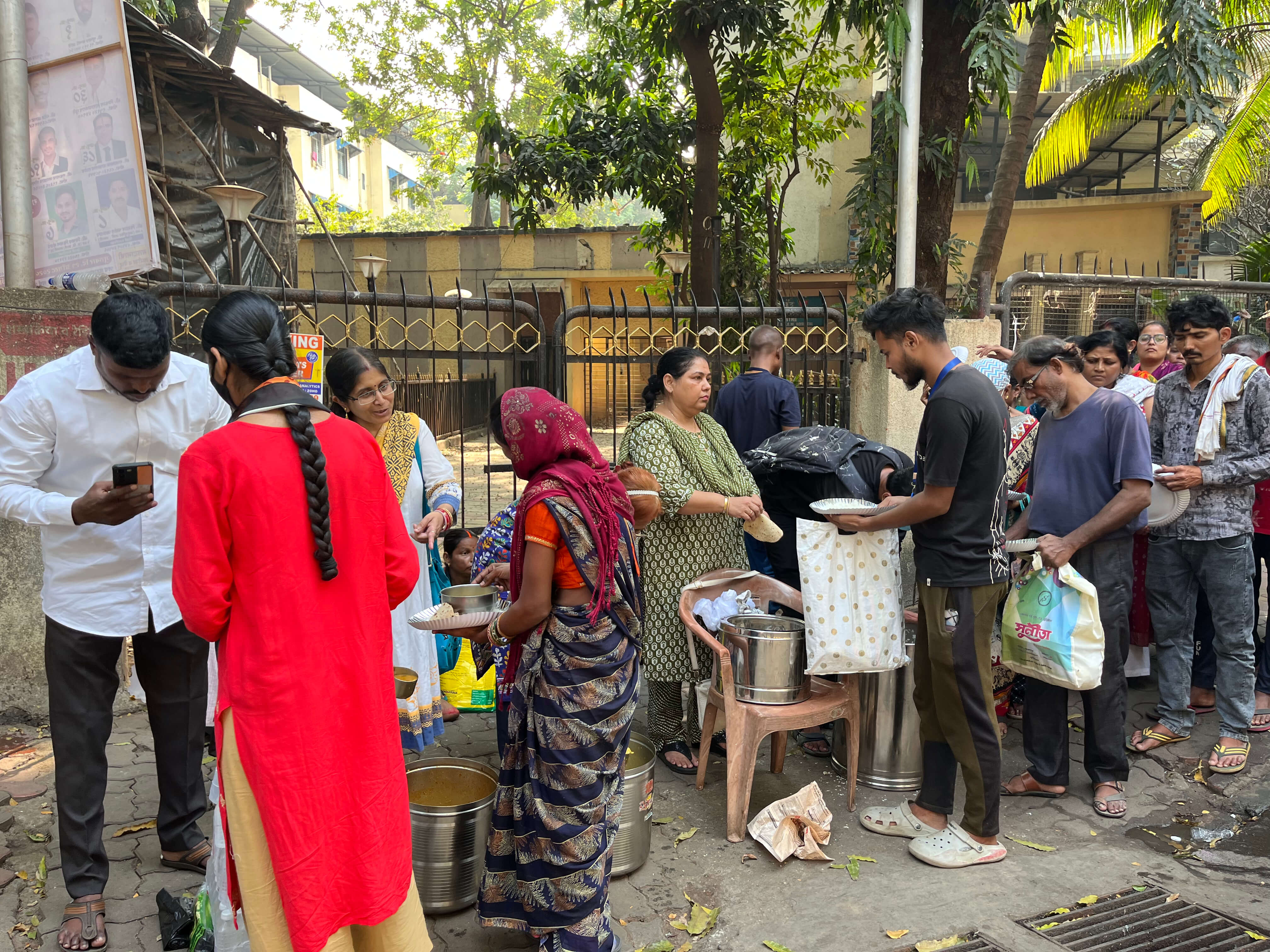 Volunteers serving food to people in need